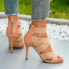 Stylish emerald green stiletto sandals featuring a zip-up back.