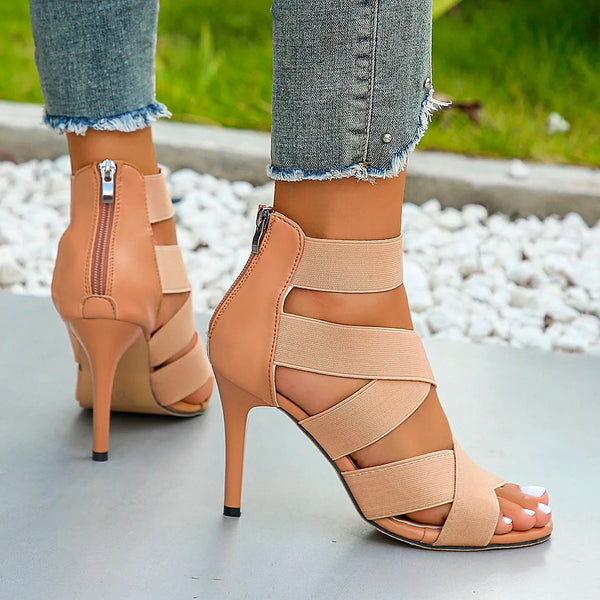 Stylish emerald green stiletto sandals featuring a zip-up back.