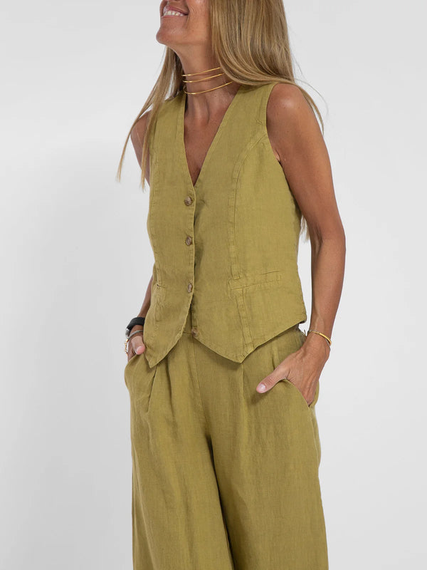 Model adjusting the V-neck of the Radiant Summer Suit, showcasing its elegance.