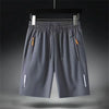 Breathable polyester shorts with zipper pocket lying flat on white background