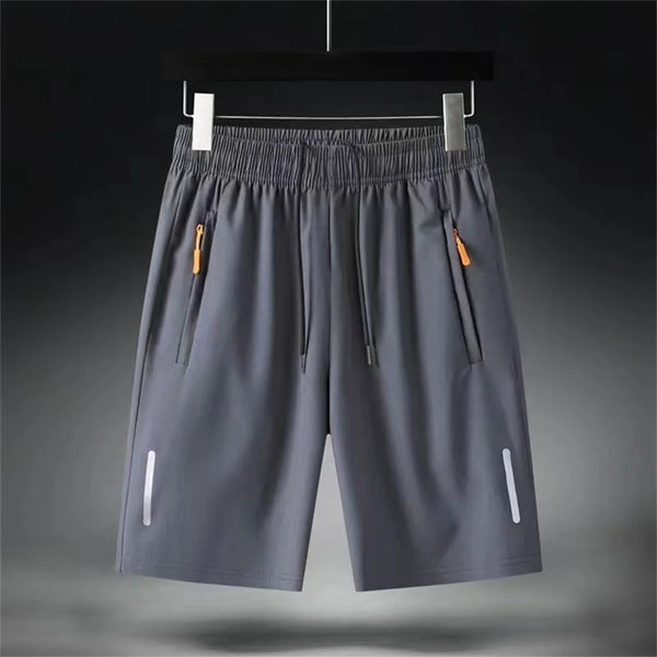 Breathable polyester shorts with zipper pocket lying flat on white background