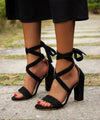 Elegant metallic stiletto sandals with ankle-wrap and easy zip closure.