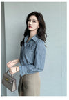 Chic striped blouse for office elegance, featuring a turn-down collar and single-breasted closure, perfect for professional w