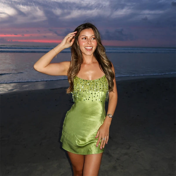 Above-knee green sequined party dress with square neckline and tassel embellishments