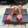 Crystal-clear heels with pointed toe and patent leather accents