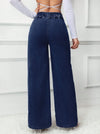 Detail shot of the waistband on high-waisted jeans, emphasizing comfort and fit.