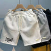 Breathable printed men's shorts in polyester with knee-length design and regular fit for active comfort
