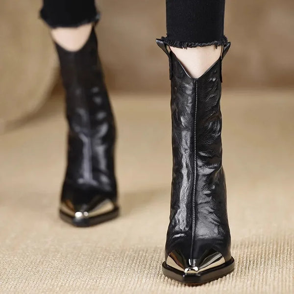 Sleek black ankle boots with mirror-shine patent finish and stable block heel