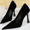 Elegant black stiletto high heels with pointed toe design.