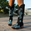 Embroidered mid-calf women's fashion boots with low wedge heel, slip-on design, and durable rubber outsole for comfort.