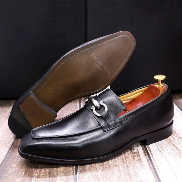 Close-up of rubber outsole traction pattern on black dress loafers