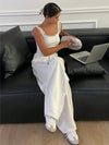 Oversized white denim jeans with relaxed wide leg cut and elevated waistline