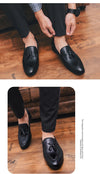 Detailed shot of the faux leather texture on charismatic tassel loafers.