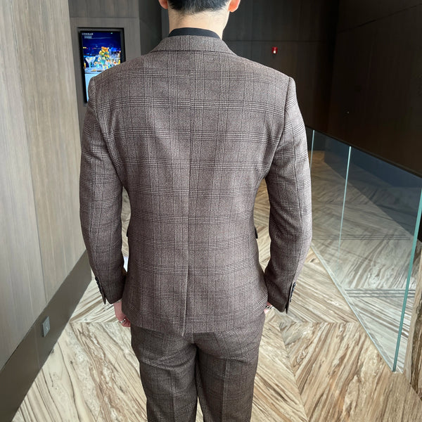 Model walking confidently in the Autumn Charisma plaid suit at an event.