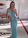 Ankle-length backless dress with halter neckline and flattering waist cutout details
