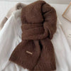 Hand wash recommended label on the cozy knitted scarf, ensuring easy care for long-lasting use.