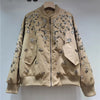 Detail shot of spliced seams and sequin embroidery texture on jacket surface