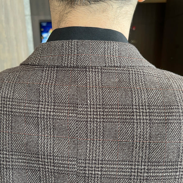 Close-up of the suit's buttons, highlighting the attention to detail.