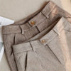 Tailored high-waist pants in premium polyester broadcloth with functional pockets and button front closure