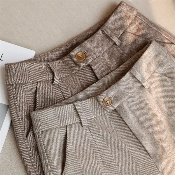 Tailored high-waist pants in premium polyester broadcloth with functional pockets and button front closure