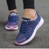 Women's cushioned white sports shoes with multi-color design elements