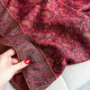 Sophisticated paisley pashmina draped over a casual outfit.
