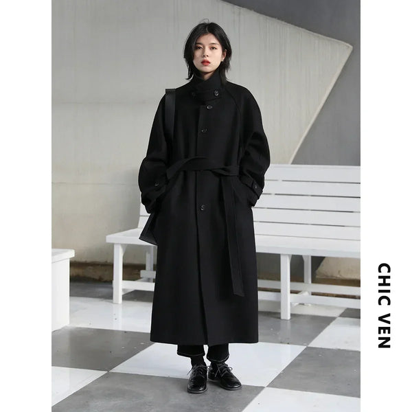 Sophisticated long-length trench coat with turtleneck collar and belt accent