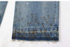Trendy washed and ripped wide-leg women's jeans with distressed ink-splashed finish, mid-rise, and zipper fly closure.