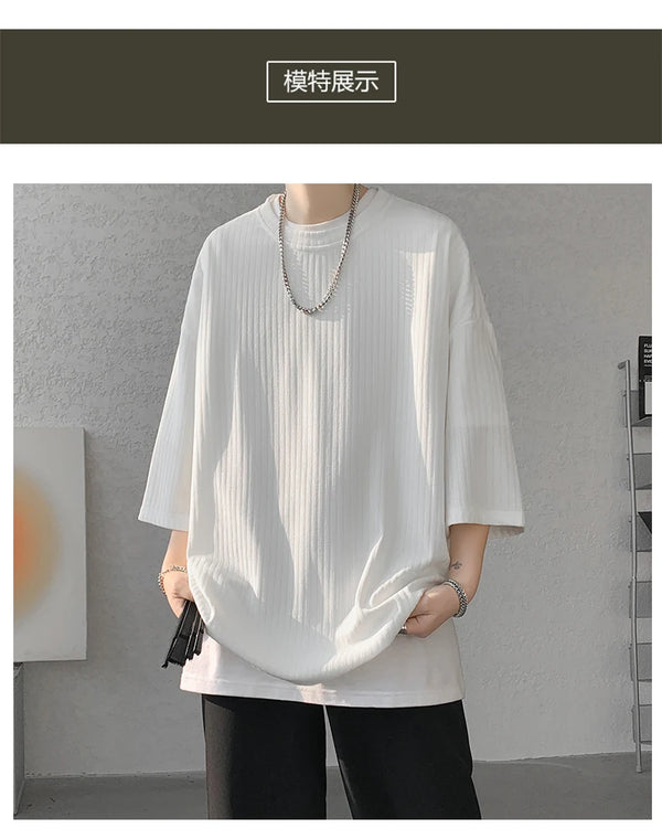 Unisex striped summer tee displayed on hanger, showcasing loose fit and vibrant stripes.