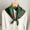 Women's fashion accessory, elegant green scarf with luxurious silk-like feel.