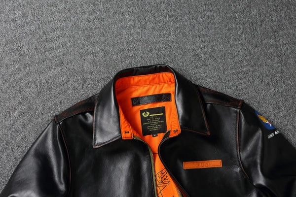 Vintage A2 leather flight jacket displayed against a rustic background.