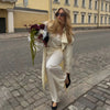 Timeless cream trench coat with adjustable belt creating defined waist shape