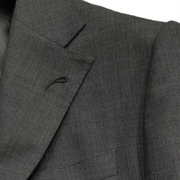 Close-up of Milanese lapel buttonhole and pick stitching on a luxury wool suit, highlighting fine details.