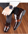 Detailed view of brogue design on brown leather Oxford shoes.