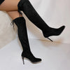Black suede over-the-knee boots with lace-up ribbon detail and slim high heels on white background