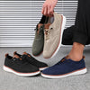 Close-up of knitted mesh upper on men's gray walking shoes with ventilated design