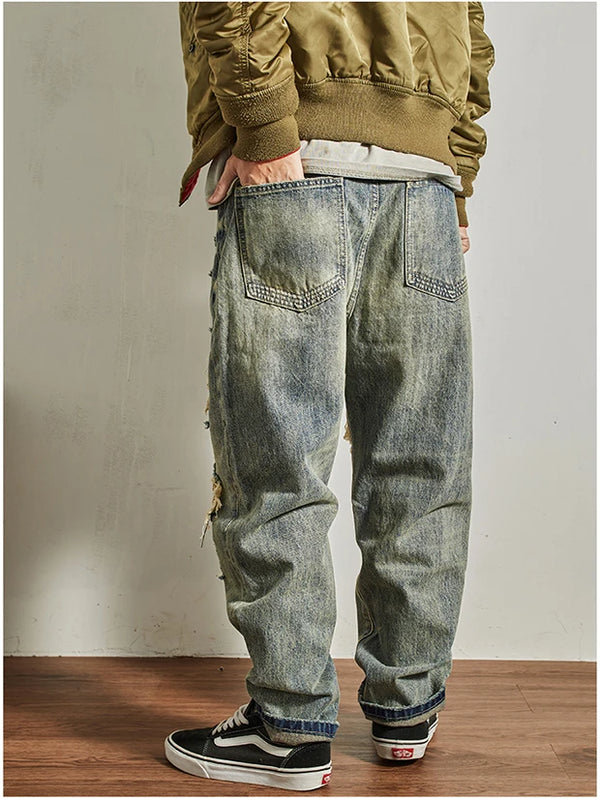Rebel Spirit Distressed Jeans on a wooden surface, reflecting an adventurous lifestyle.