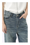 Men's washed blue denim jeans with wide leg cut and functional design