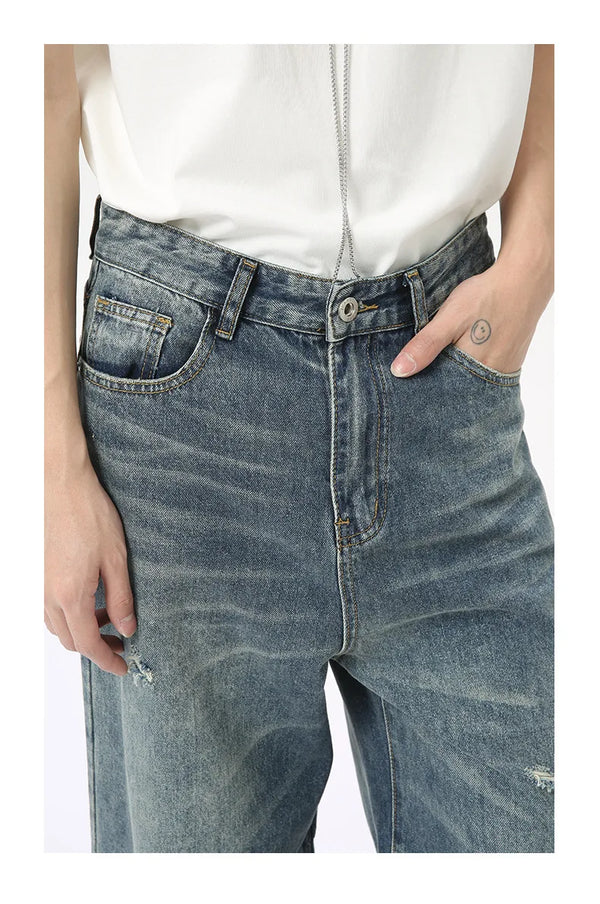 Men's washed blue denim jeans with wide leg cut and functional design