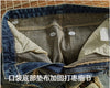Rebel Spirit Distressed Jeans paired with a beanie for a stylish, casual outfit.