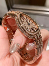 Side view of the luxury watch highlighting its delicate snake-pattern design.
