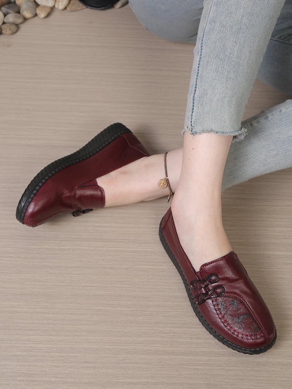 Detail shot of flower-embellished leather loafer with cushioned comfort insole