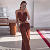 Summer formal dress with halter top, backless silhouette, and waist cutout accents