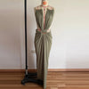 Sleek polyester dress featuring backless silhouette and curve-enhancing waist cutouts