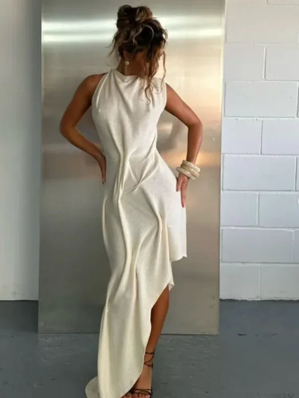 Sophisticated ruched halter dress with elongating neckline and asymmetrical flowing hem