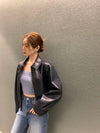 Chic cropped leather jacket for women in faux leather, featuring a turn-down collar and zipper closure, perfect for autumn an