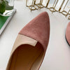 Woman slipping on knitted ballet flats demonstrating easy slip-on convenience
