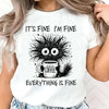 Woman wearing white graphic tee with cat and coffee cup design paired with casual jeans