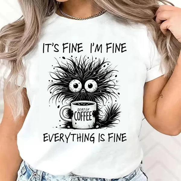 Woman wearing white graphic tee with cat and coffee cup design paired with casual jeans