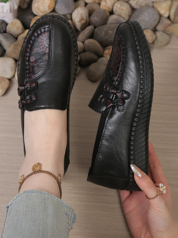 Sophisticated leather loafers showcasing subtle flower detail and premium construction